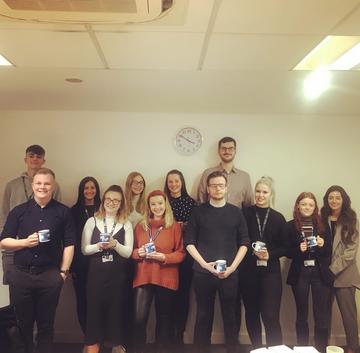 Apprentice ambassadors together for 'Tea & Chat' during National Apprenticeship Week, holding themed mugs